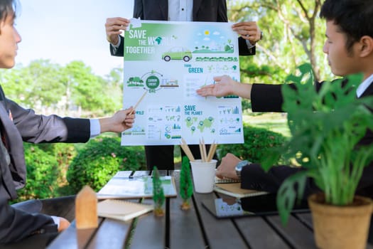 Group of asian business people presenting environmentally friendly development plan and sustainable technology project for greener future, establishing outdoor eco business office at natural park.Gyre