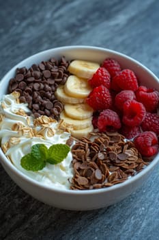 a bowl of yogurt and berries on the table. The concept of healthy food.