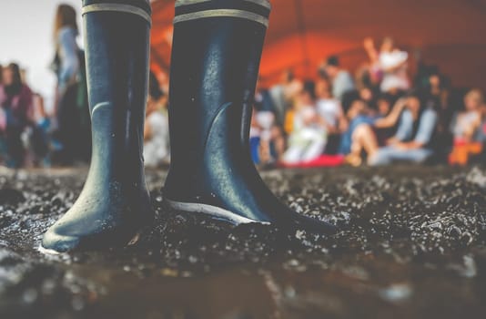 Rubber Boots In The Mud At A Music Festival, With Copy Space