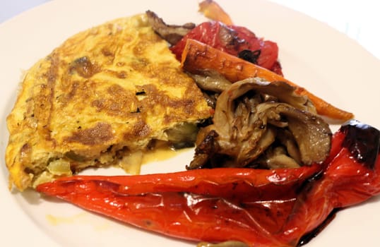 Savor the delightful combination of oven-roasted veggies paired with a fluffy omelette