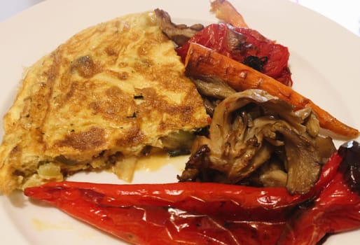 Savor the delightful combination of oven-roasted veggies paired with a fluffy omelette