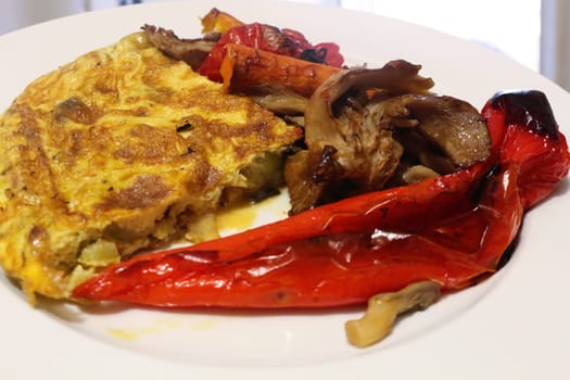 Savor the delightful combination of oven-roasted veggies paired with a fluffy omelette