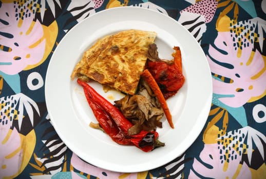 Savor the delightful combination of oven-roasted veggies paired with a fluffy omelette