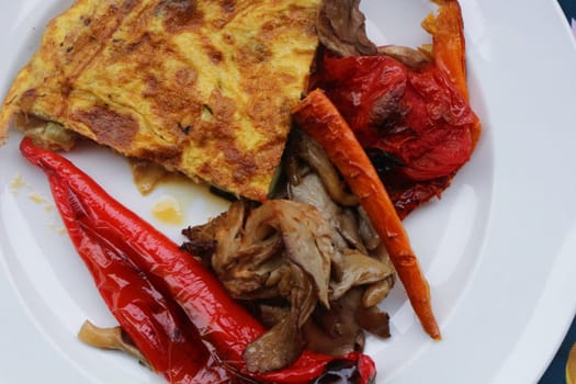 Savor the delightful combination of oven-roasted veggies paired with a fluffy omelette