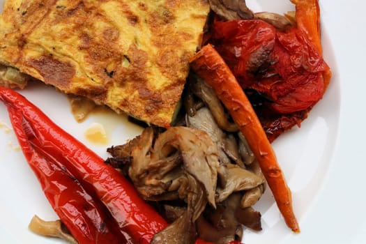 Savor the delightful combination of oven-roasted veggies paired with a fluffy omelette