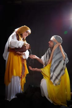 A couple in love or a married couple in stylized Eastern clothing from Israel, Palestine, Iran, Pakistan together. Tender photo session in the style of the Middle East and the Bible