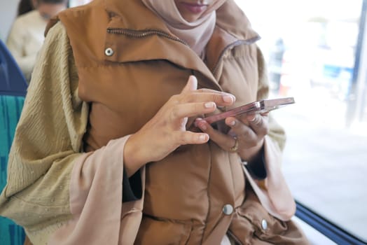 young women using smart phone inside of metro train .
