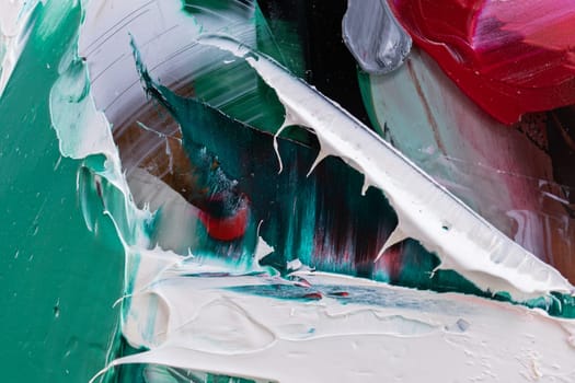 Fragment of multicolored texture painting on plywood. Abstract art background. oil on canvas. Rough brushstrokes of paint. Closeup of a painting by oil and palette knife. Highly-textured, high quality details.