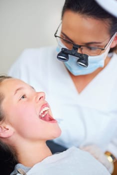 Dentist, consultation and woman with girl, kid and checkup for teeth whitening and oral healthcare. Professional, child and patient with medical procedure and appointment with dental hygiene or trust.