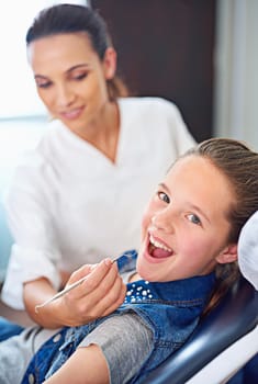 Portrait, girl and dentist with kid, consultation and appointment for medical procedure and oral health. Face, professional and child with nurse and dental hygiene with care and trust with checkup.