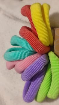 bright multi-colored fabric hair ties, women's accessories, objects. High quality photo