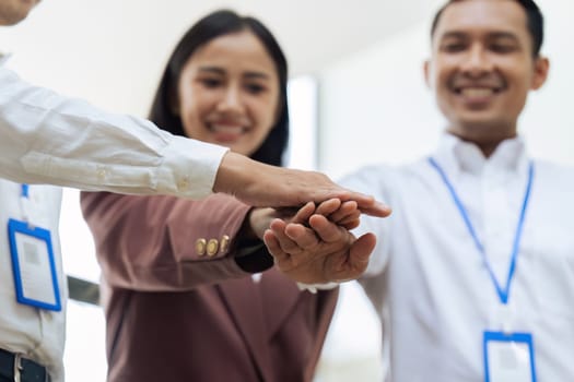 Closeup hand of Businesspeople unity between business people with their hands stacked for project development and innovation.