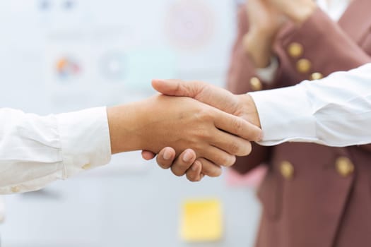 Closeup Handshake of employees after successful planning strategy marketing in the office.