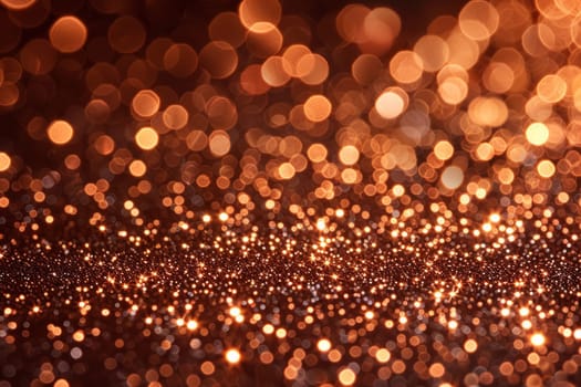 Abstract blur of shimmering gold glitter against a dark black background.