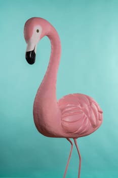 Decorative figure of pink flamingo on blue background.