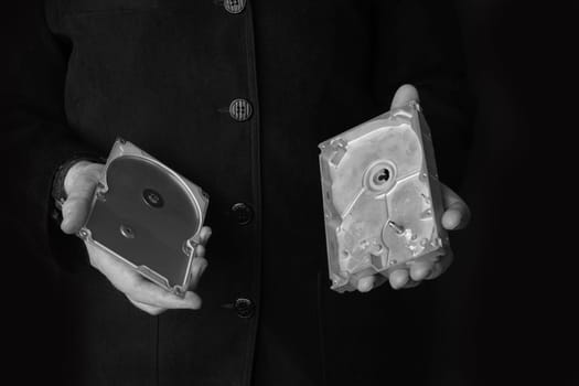 A man holds an empty opened hard disk in his hands. Identity theft or corporate secret concept.