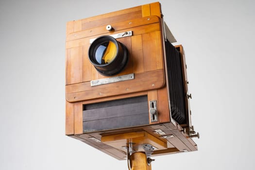 An old wooden camera of the last century with an accordion.