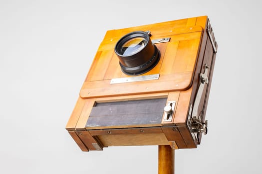 An old wooden camera of the last century with an accordion.