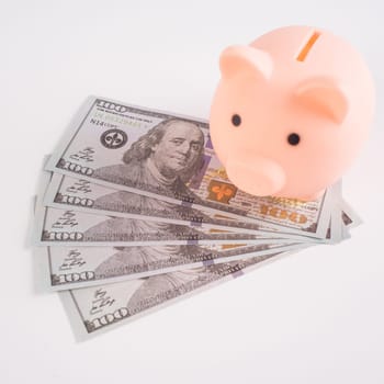 pig piggy bank on american dollar bills on white background.