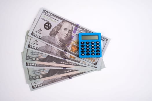 Blue calculator and dollars on a white background.