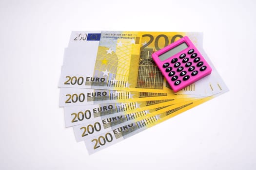 Pink calculator and euro on a white background.