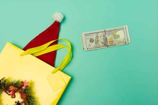 top view yellow shopping bag with santa hat and money on the table with the holiday season