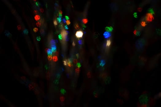 Christmas background. Festive abstract background with bokeh defocused lights and stars.