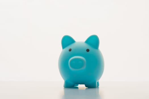 Blue piggy bank isolated on white background.