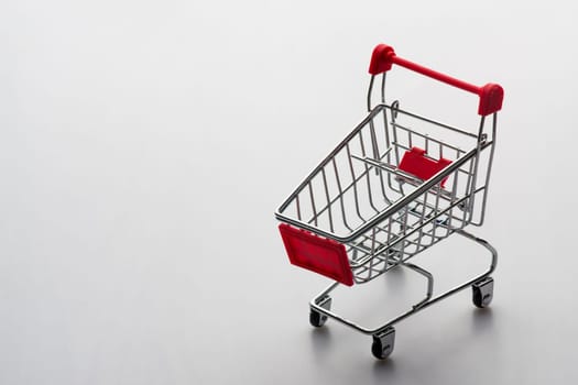 Empty grocery shopping cart. Isolated over white background.