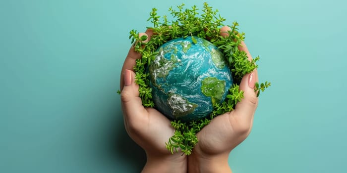 Hands holding green planet Earth globe with plants. Environmental conservation and sustainability concept.