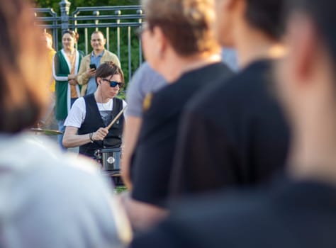 Moscow, Russia - 07.09.2023 - Visitors enjoying street band performance next to VDNKH metro station.