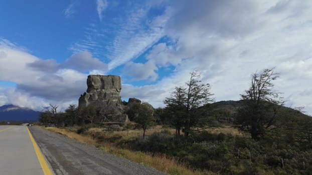 A scenic drive in Patagonia, Chile, featuring the prominent Devil's Rock by the roadside.