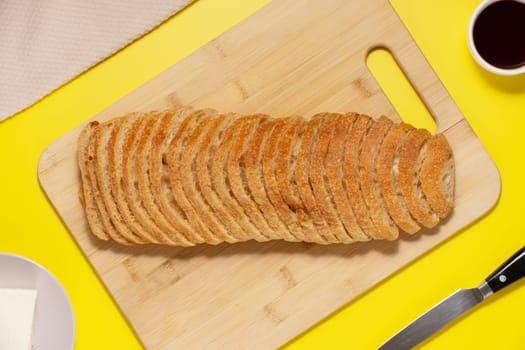 Ciabatta bread sliced on a board, top view.