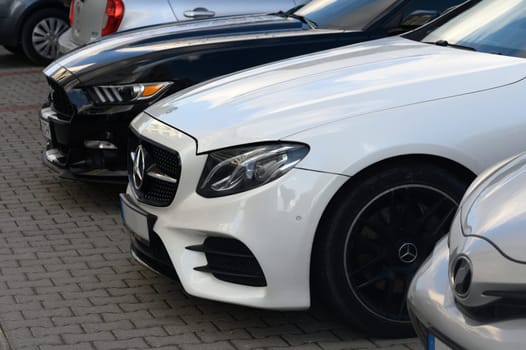 Gaziveren Cyprus 14/03/2024 - white Mercedes and black and white Ford Mustang front and side views 1