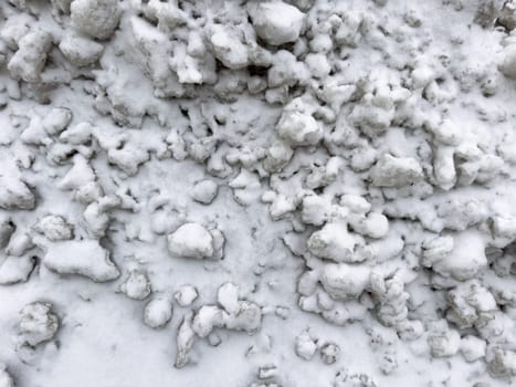 texture pieces of white snow lie on the road