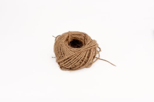 a ball of coarse thread highlighted on a white background