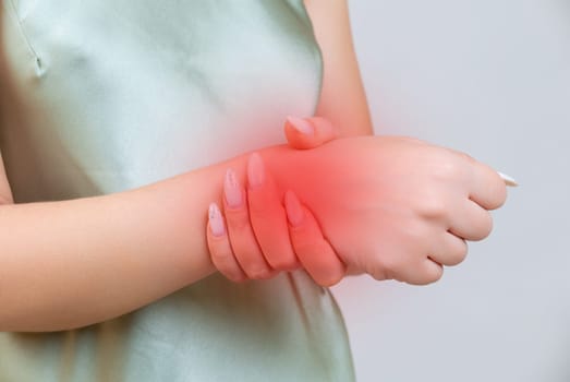 young woman experiencing pain in the joint of the hand