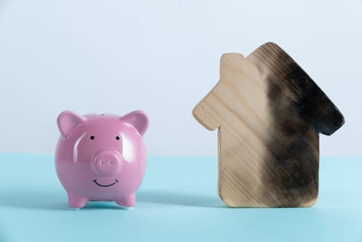 burn house and Piggy bank. Fire insurance concept