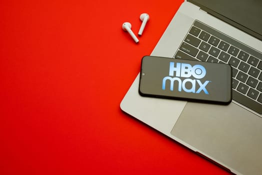 Tula, Russia - Jan 10, 2022: HBO Max logo on smartphone screen on red background.