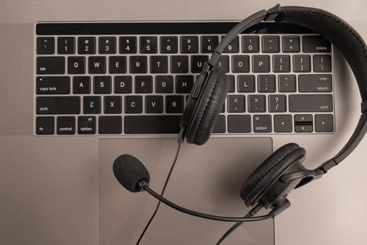 headset on keyboard computer laptop, call center support and customer service help, concept for communication