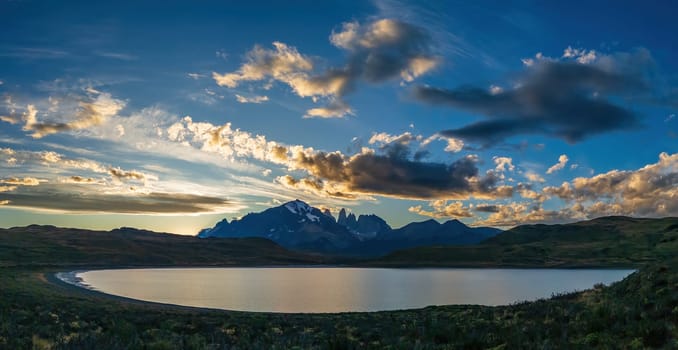 Captivating sunset and cloudscape above tranquil mountain lake in Torres del Paine
