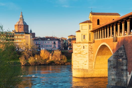 Landscape of Ponte Coperto (covered bridge) and Duomo di Pavia (Pavia Cathedral) in Pavia at sunny day, Lombardy, italy.