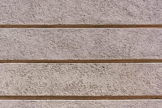 Beautiful exterior wall of a renovated house painted with a soft light color, enriched with a geometric horizontal striped texture. This design adds a contemporary and elegant touch 5