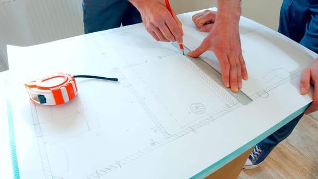 Project development of a large building. The foreman draws the scheme of the house.