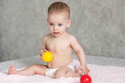 The child froze in delight and throws away the colored balls he is playing with.