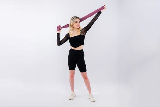 Photo of woman workout with a resistance band. Strength and motivation.