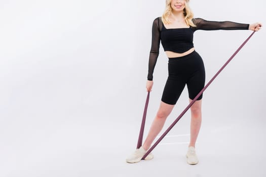 Photo of woman workout with a resistance band. Strength and motivation.