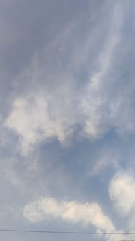 Blue gray light sky nature white clouds whether background, sun face . High quality photo