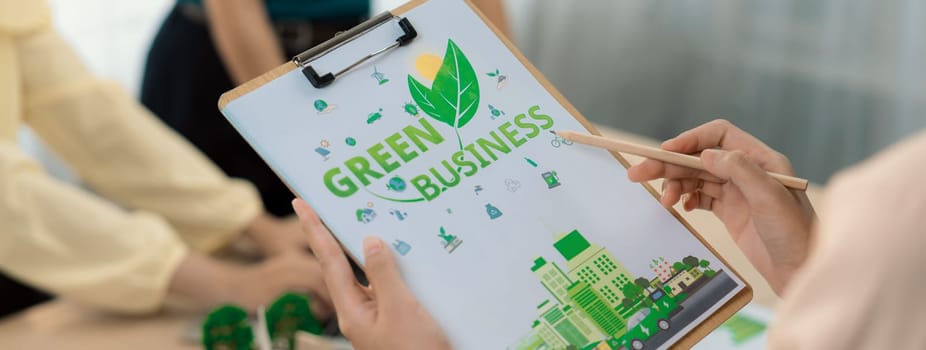 Green business project was presented by green business team at meeting room. ESG environment social governance and Eco conservative concept. Blurring background. Closeup. Delineation.