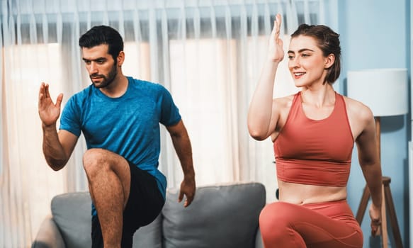 Athletic and sporty fitness couple or exercise buddy running posture at home body workout exercise session for fit physique and healthy sport lifestyle at home. Gaiety home exercise workout training.